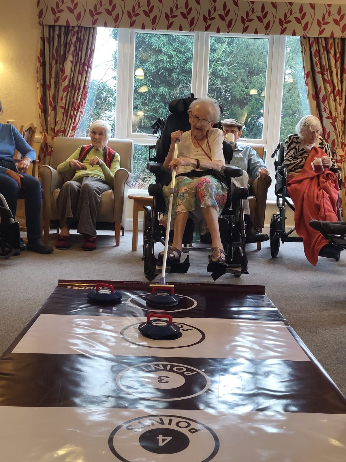 Resident at Park View Care Home Ipswich playing curling.